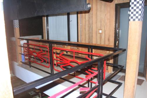 a group of red chairs sitting on a balcony at Kota Baru Homestay Jepara in Jepara