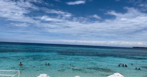 a group of people in the water at the beach at Tours Mandala Beach in Baru