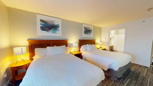 a hotel room with two beds and two lamps at TownePlace Suites Fredericksburg in Fredericksburg