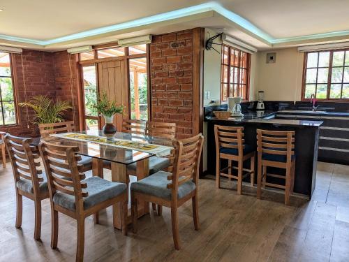 a kitchen with a dining room table and chairs at Casa de Campo Don Panchito 