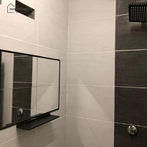 a bathroom with a mirror and a shower at Shahanis Homestay. A hotel-like stay experience! in Kijal