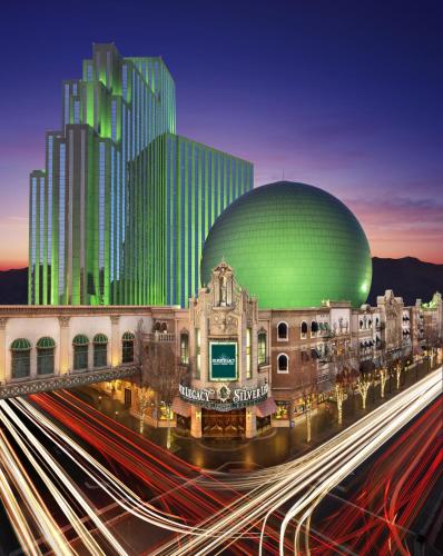 a city with a building and a street with cars at Silver Legacy Reno, A Caesars Destination in Reno