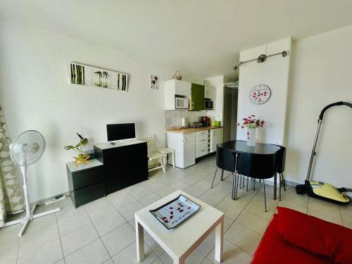 un salon avec une table et une cuisine dans l'établissement Studio rénové, 4 pers, parking privé, proche port et plage - Cap d'Agde - FR-1-723-127, au Cap d'Agde