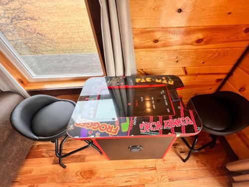 una mesa de cristal con TV junto a dos sillas en 3 Master Bedrooms - Sleeps 10 - Location - Game Room - Hot Tub, en Pigeon Forge