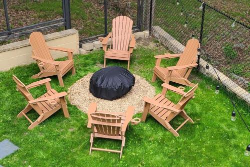 a group of chairs and a fire pit in the grass at Luxury getaway in woods, Jacuzzi, Hot Tub, Pool in Bushkill