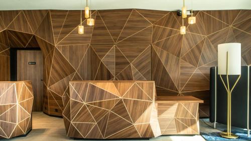 a lobby with a wooden wall with a geometric design at Crowne Plaza - Nice - Grand Arenas by IHG in Nice