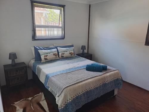 a bedroom with a bed and a window at Berlydai Guest Accomodation in Secunda