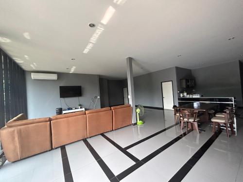 a living room with a couch and a table at WildernessMountain View in Ban Thung Ta In