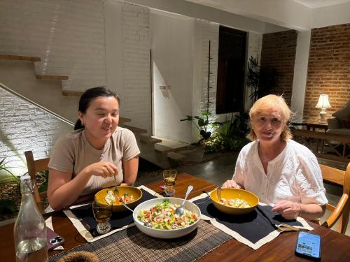 two women sitting at a table with a bowl of food at Rai Villa Colombo in Colombo