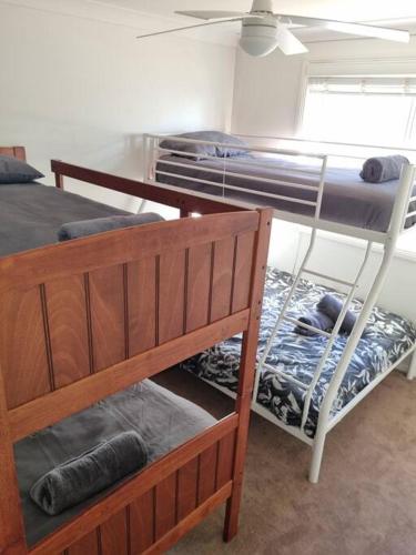 Pokój z 2 łóżkami piętrowymi i stołem w obiekcie Sunrise Retreat w mieście Tamworth