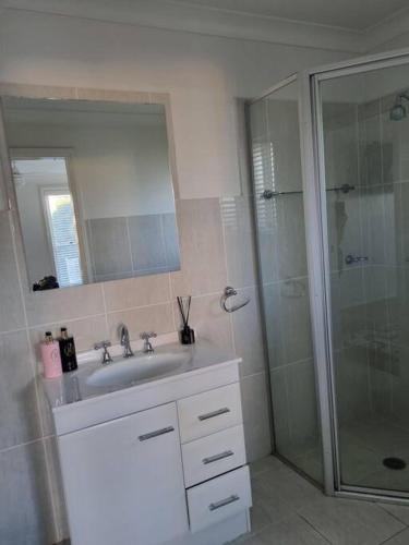 a bathroom with a sink and a shower at Sunrise Retreat in Tamworth