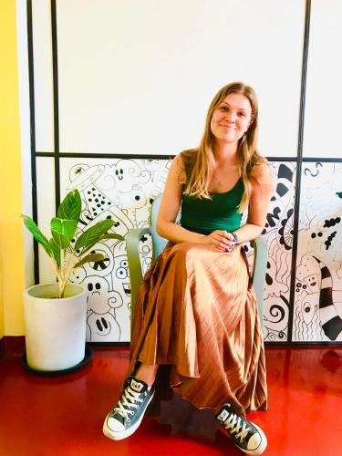 a woman sitting on a chair in a room at Railway Hostel in Matara