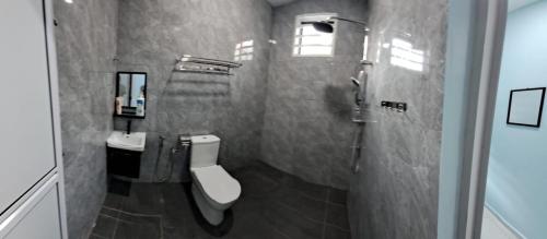a bathroom with two sinks and a toilet in it at LW homestay Bukit Setongkol near Menara 188, HTAA in Kuantan