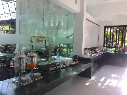 a restaurant with a counter with food on it at Green View Village Resort - SHA Plus in Ao Nang Beach