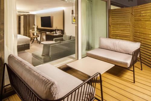 a living room with a couch and a table at Holiday Inn Milton Keynes Central by IHG in Milton Keynes