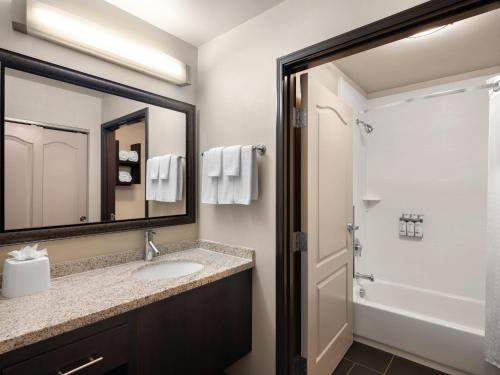 a bathroom with a sink and a mirror at Staybridge Suites Midvale, an IHG Hotel in Midvale