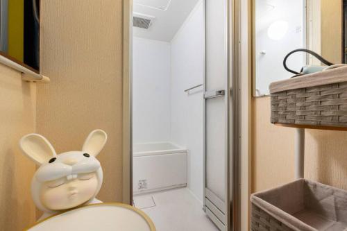 a bathroom with a rabbit head sitting on a chair at アンドステイ浮間3丁目 in Tokyo