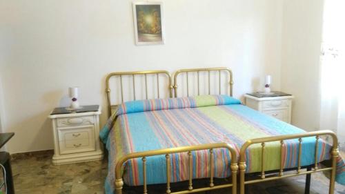 a bedroom with a bed and two night stands at Il Giardino del Gallo in Foligno
