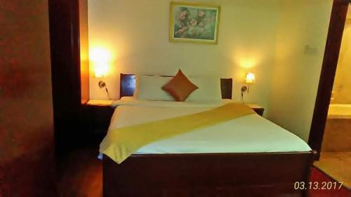 a bedroom with a bed and a desk with two lamps at Fantastic appartment at times square Kuala Lumpur in Kuala Lumpur