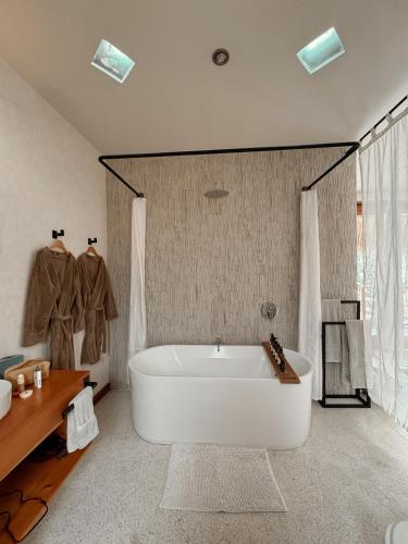 a large bathroom with a tub and a sink at Kula Maya Boutique Hotel and Spa in San Marcos La Laguna