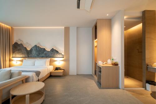 a hotel room with a bed and a couch at Timberton Resort Khaoyai in Ban Tha Maprang
