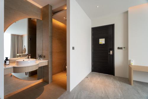 a bathroom with a white sink and a mirror at Timberton Resort Khaoyai in Ban Tha Maprang