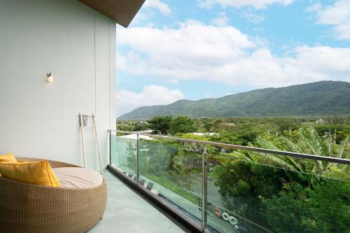 a balcony with a view of a mountain at Timberton Resort Khaoyai in Ban Tha Maprang