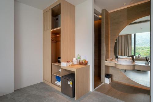 a bathroom with a sink and a mirror at Timberton Resort Khaoyai in Ban Tha Maprang