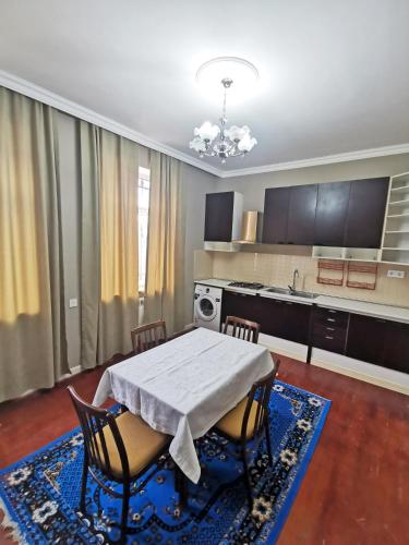 a kitchen with a table and chairs and a table and a kitchen at Bereket villa and aparts in Gabala