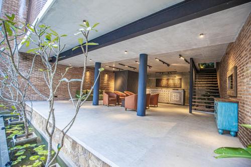 an indoor patio with chairs and a brick wall at Ella Heritage in Ella