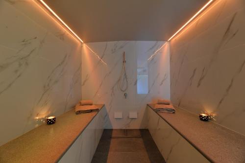 a bathroom with two sinks and marble walls at Mirivili Rooms & Suites in Athens