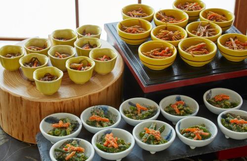 a bunch of bowls of food on a table at Yutorelo Toyako in Lake Toya