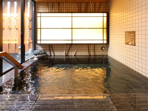 a pool of water in a room in a building at Dormy Inn Ueno Okachimachi in Tokyo