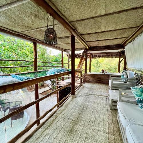 a large room with couches and chairs on a balcony at Rock and Sea Resort in Watamu