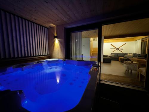 a large blue tub in a room with a living room at SOPA Zakopane in Zakopane
