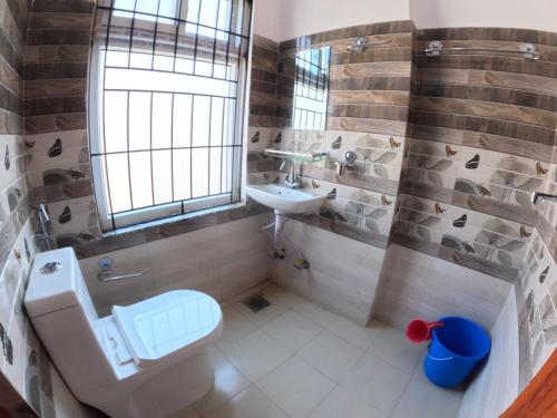 a bathroom with a toilet and a sink at Hotel Global Village in Kathmandu