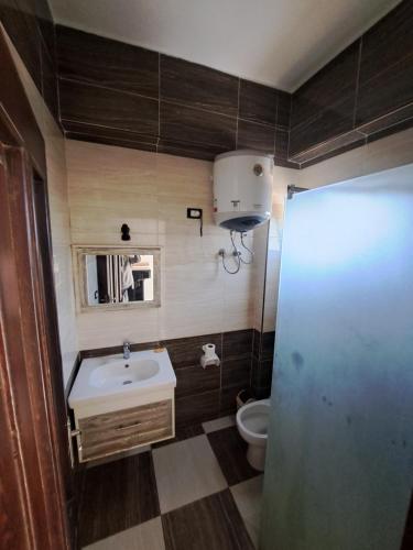 a small bathroom with a sink and a toilet at Santa maria dahab hotel in Dahab