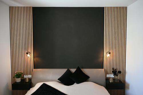 a bedroom with a bed with black and gold stripes at ADRIANIK Apartment in Zagreb