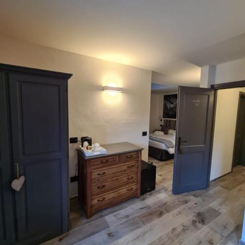 a bedroom with a blue door and a bed at Hotel Dente Del Gigante in Courmayeur