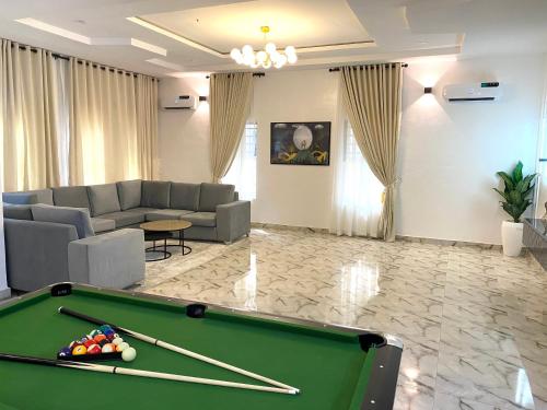 a living room with a pool table and a couch at Luxe Haven Lekki in Lekki