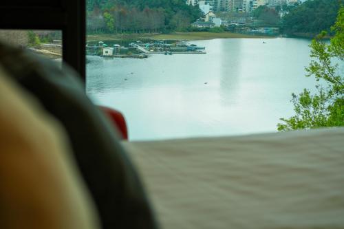 a view of a lake from a bus window at Zhaohong homestay in Yuchi