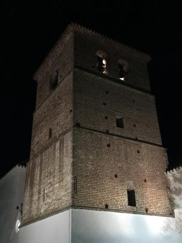 a tall brick tower with two windows on top at Apartamento Doña Pia in Mijas