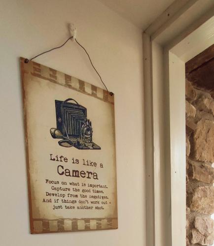 a picture of a sign hanging on a wall at The Old House at Belfield in Tralee