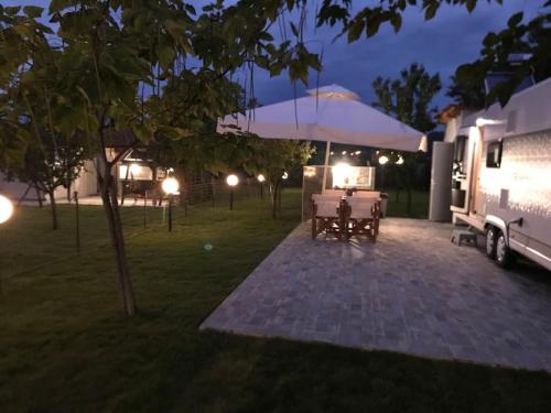 a rv parked in a yard at night at Delightful RV Camper In a Peaceful Area near Sea. in Skala Fourkas