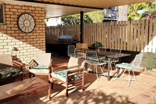 a patio with a table and chairs and a grill at Peaceful Getaway - Stylish, Newly Updated House in Brisbane