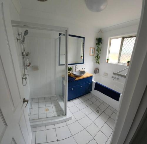 a bathroom with a shower and a sink at Peaceful Getaway - Stylish, Newly Updated House in Brisbane