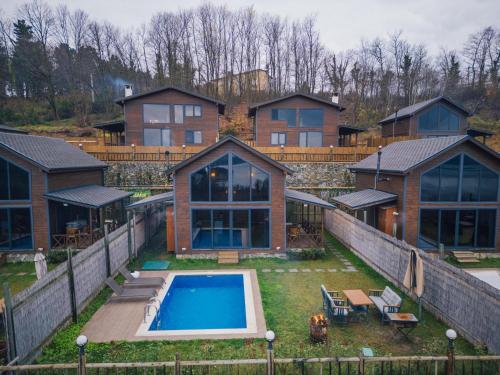 a large house with a swimming pool in the yard at Woodlodge Country Sapanca in Sapanca