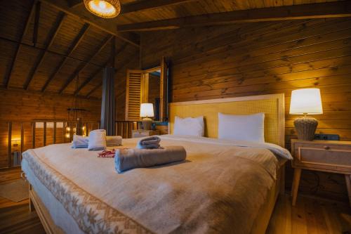 a bedroom with a large bed in a wooden room at Woodlodge Country Sapanca in Sapanca
