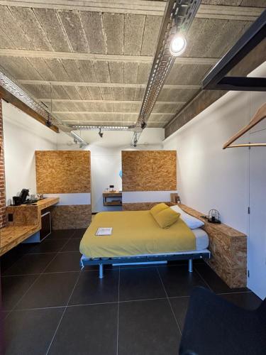 een slaapkamer met een bed en een bureau in een kamer bij La Maraudeuse in Theux