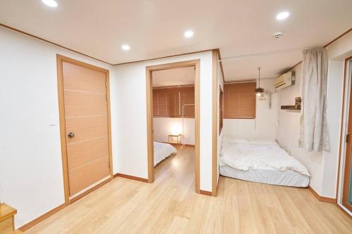 una camera con un letto e un grande specchio di Mapo Villa in Shinchon a Seul